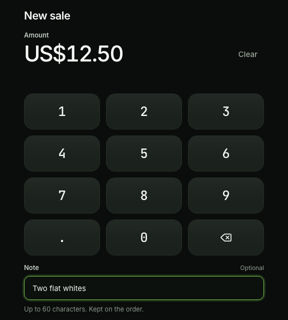 The till's keypad on a tablet with US$12.50 typed, a note, and Charge US$12.50.